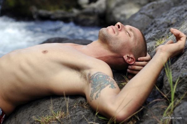 young sexy caucasian man, relaxing near a river