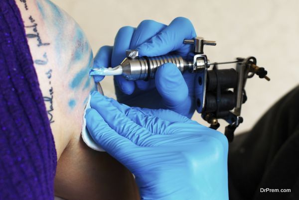 hands of tattooist creat a tattoo