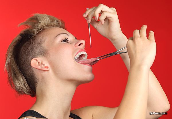 Woman piercing the tongue herself